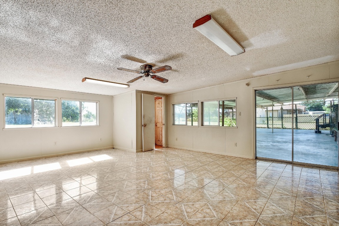 17398 Benton City Road Von Ormy, TX 78073 - Photo 21 of 25 a view of empty room with wooden floor and fan