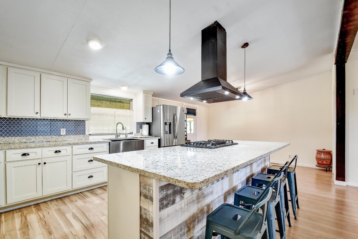 17398 Benton City Road Von Ormy, TX 78073 - Photo 8 of 25 a kitchen with stainless steel appliances granite countertop a kitchen island a stove a table and chairs
