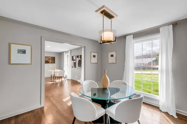 a view of a dining room with furniture wooden floor and chandelier