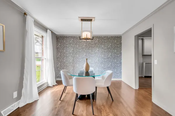 a view of a dining room with furniture window and wooden floor