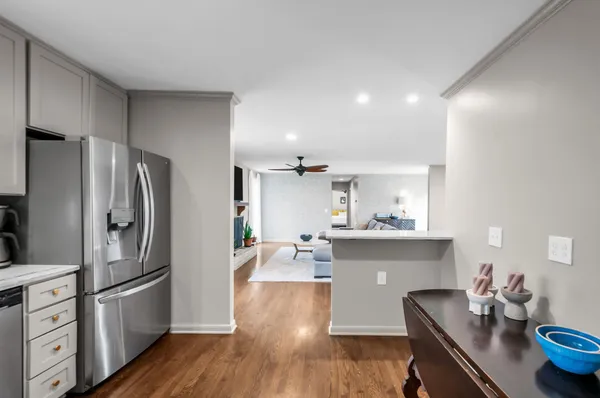 a kitchen with stainless steel appliances a refrigerator and wooden floor