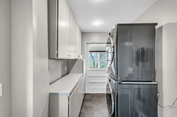 a kitchen with a refrigerator and white cabinets