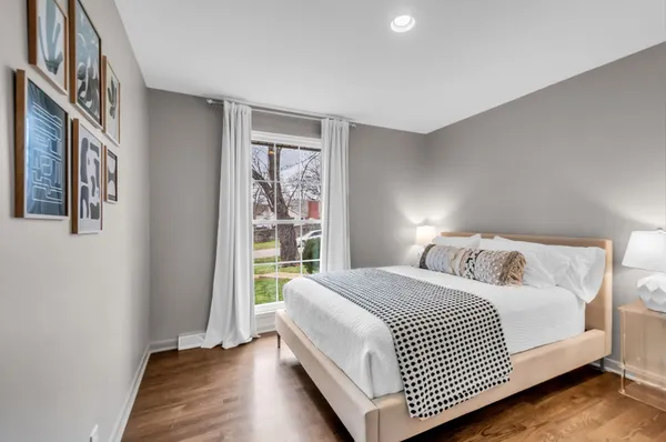 a bedroom with a bed and a window