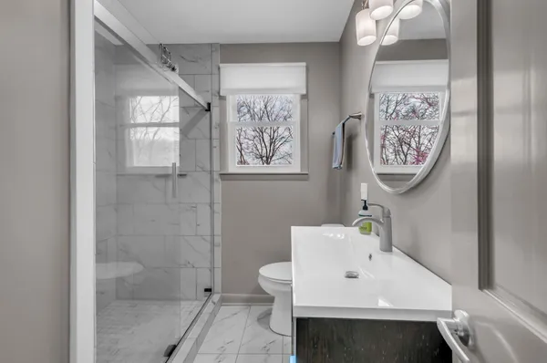 a bathroom with a sink toilet and a shower