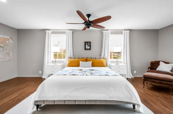 a bedroom with a bed and wooden floor