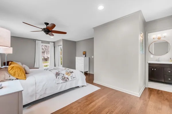 a bedroom with a bed and wooden floor