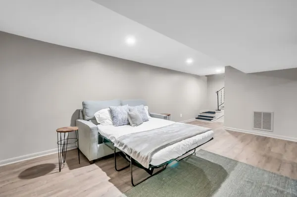 a bedroom with a bed and two night stand
