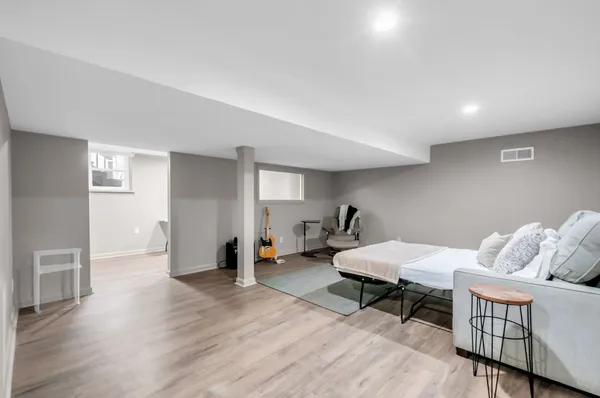 a living room with furniture and wooden floor