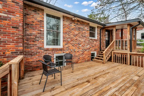 a balcony with chairs and wooden floor