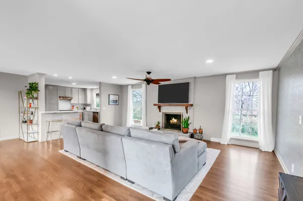 a living room with furniture a fireplace and a flat screen tv