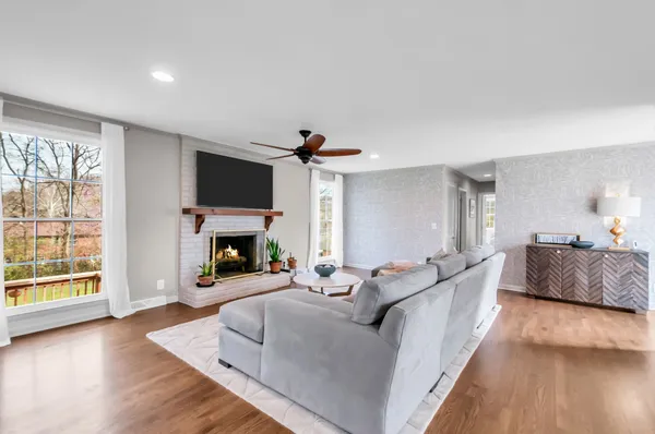 a living room with furniture a fireplace and a flat screen tv