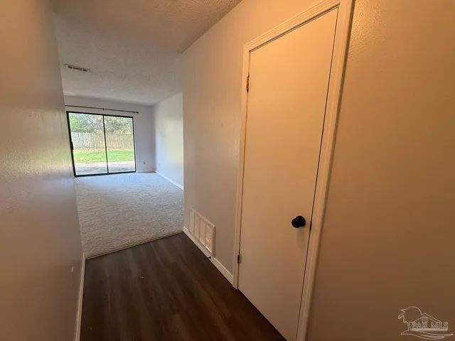 a view of hallway with wooden floor
