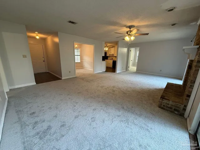a view of a hallway with workspace and a window