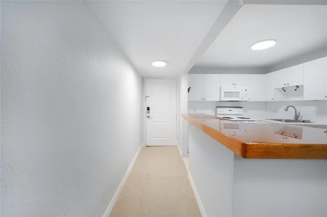 a large kitchen with stainless steel appliances granite countertop a sink stove and cabinets