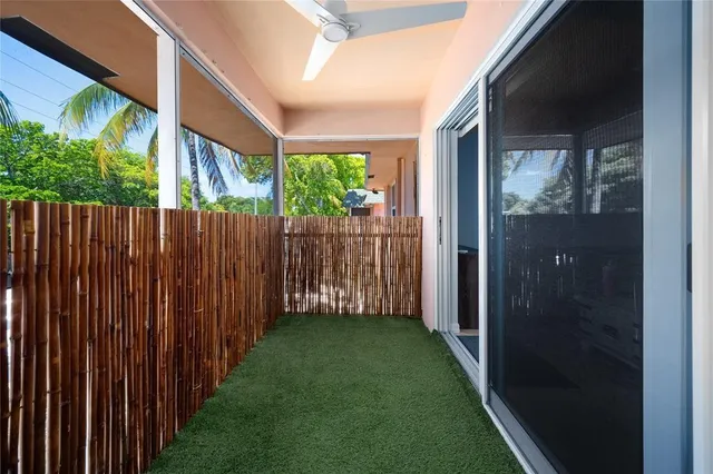 a view of a backyard with wooden fence