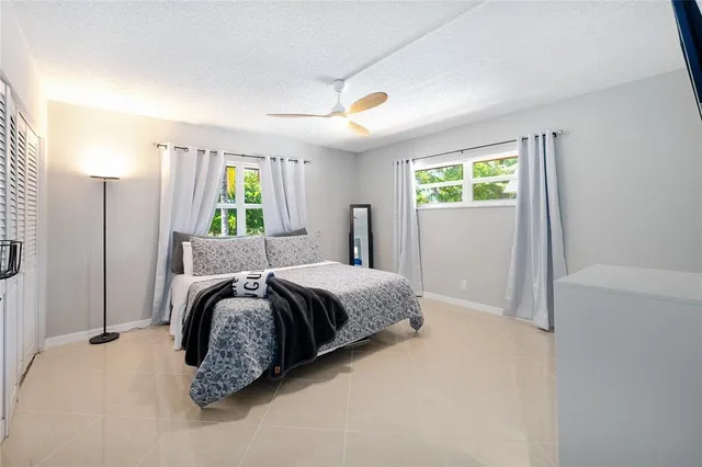 a bedroom with a bed dresser and a window