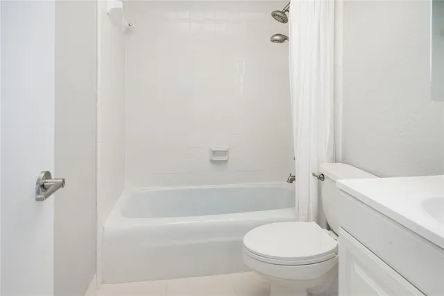 a bathroom with a toilet and a bath tub