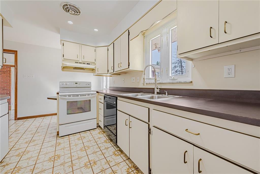310 Longwood Drive Irwin, PA 15642 - Photo 15 of 25 a kitchen with granite countertop white cabinets stainless steel appliances and sink