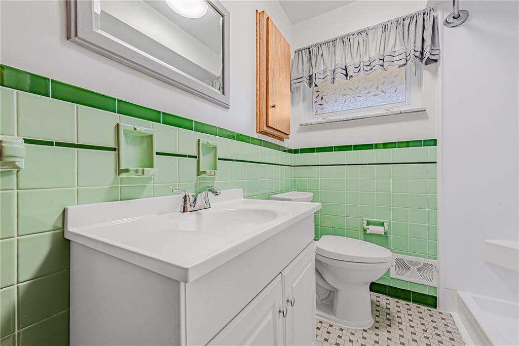 310 Longwood Drive Irwin, PA 15642 - Photo 19 of 25 a bathroom with a sink a toilet and mirror