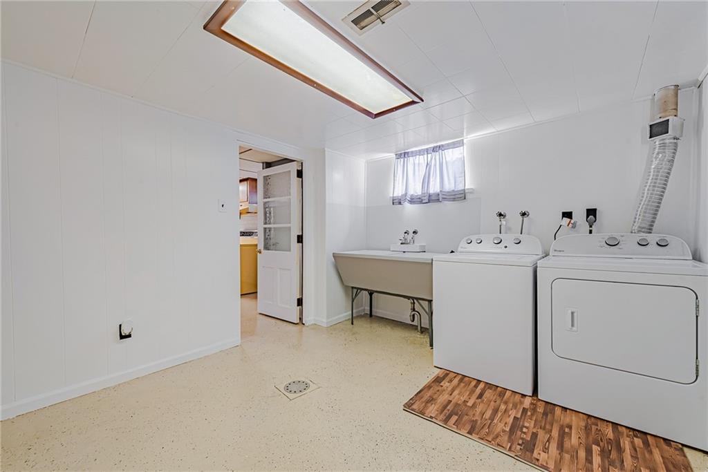 310 Longwood Drive Irwin, PA 15642 - Photo 24 of 25 a utility room with cabinets washer and dryer