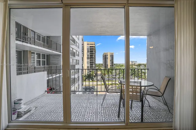 a spacious bedroom with a bed a table and chair