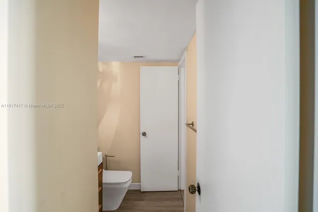 a bathroom with a sink toilet and mirror