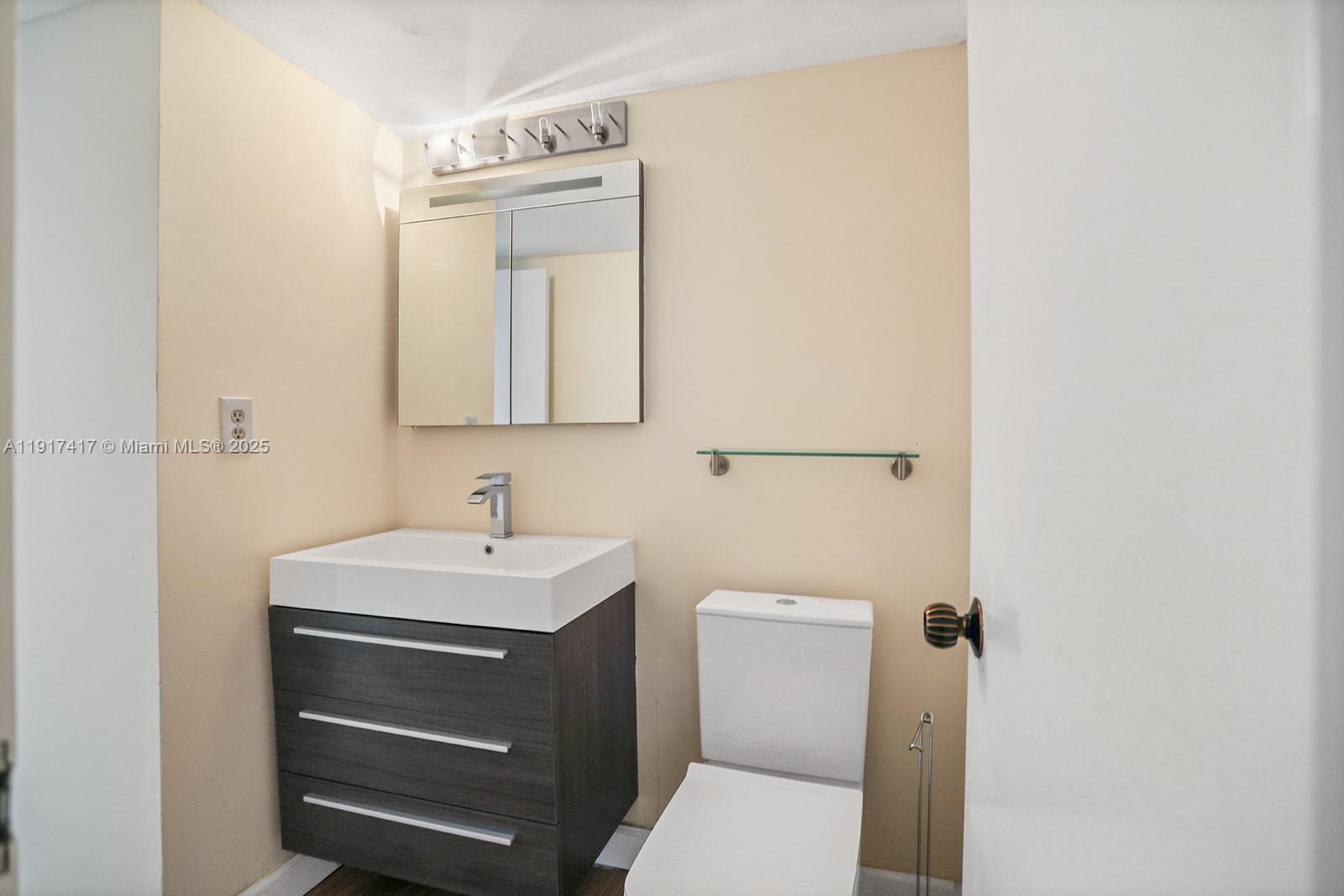 2030 South Ocean Drive, Unit 503 Hallandale Beach, FL 33009 - Photo 28 of 41 a bathroom with a sink toilet and mirror