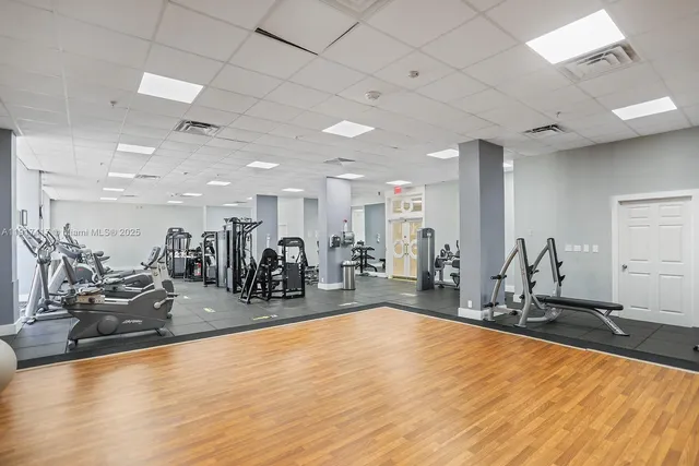 a gym room with lots of gym equipment