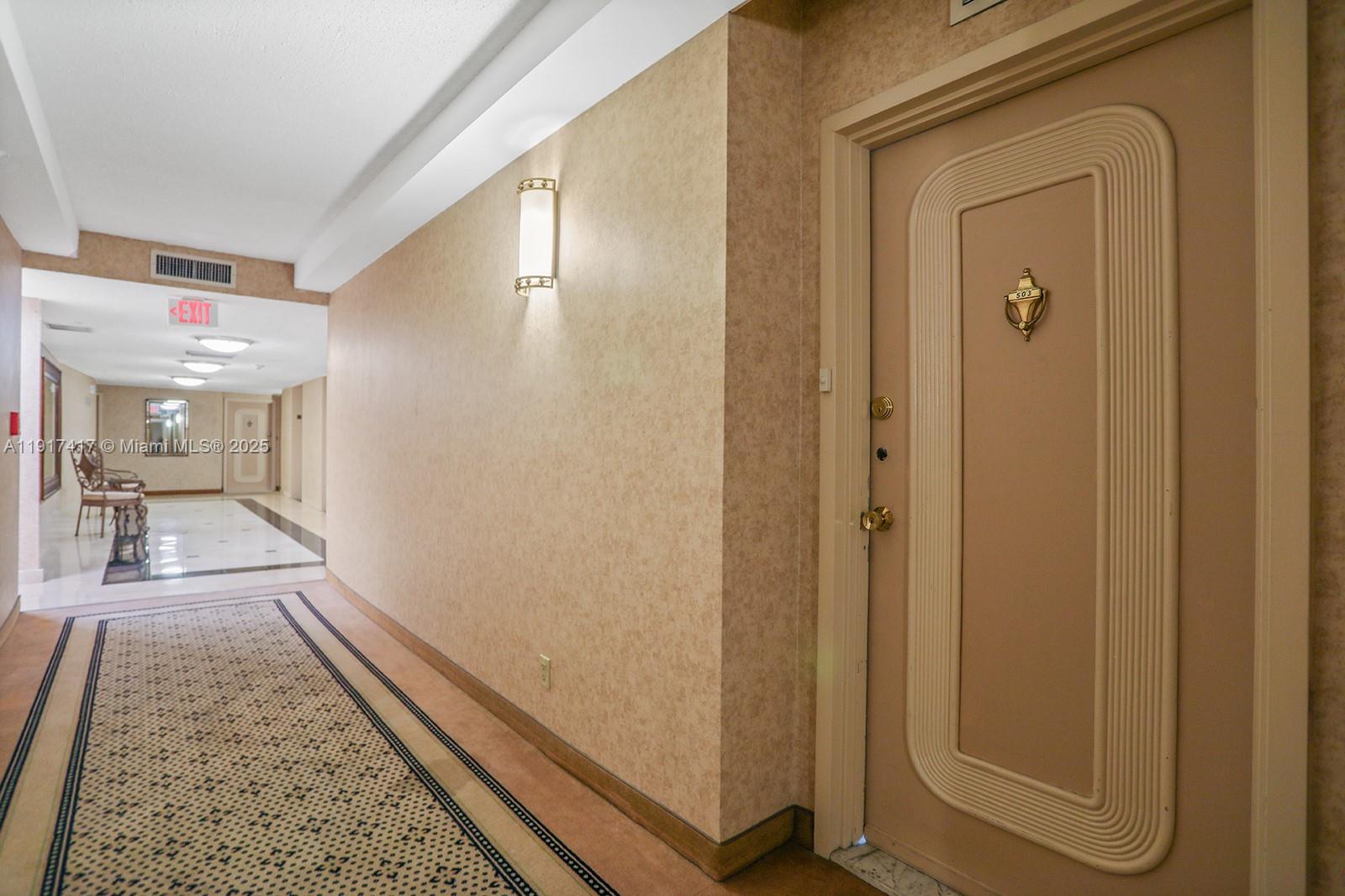 2030 South Ocean Drive, Unit 503 Hallandale Beach, FL 33009 - Photo 6 of 41 a view of a hallway with wooden floor and a bathroom