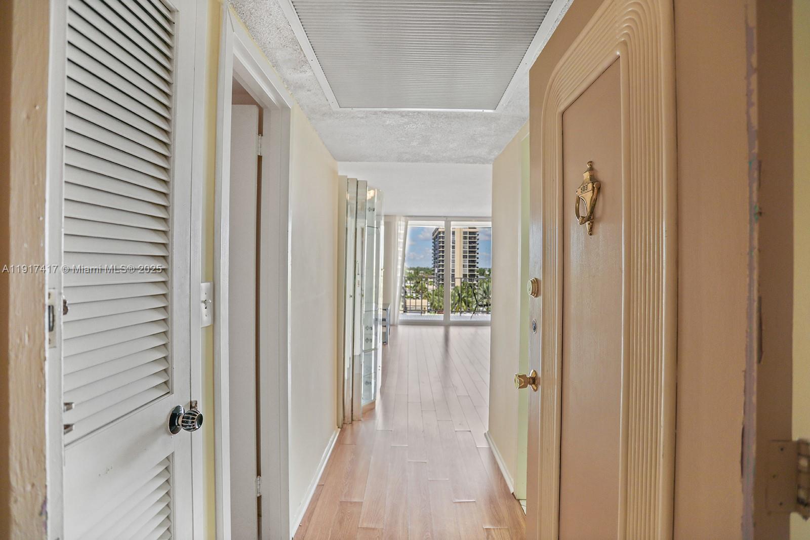 2030 South Ocean Drive, Unit 503 Hallandale Beach, FL 33009 - Photo 7 of 41 a view of a hallway with wooden floor windows and a bathroom