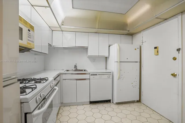 a kitchen with appliances cabinets and a sink