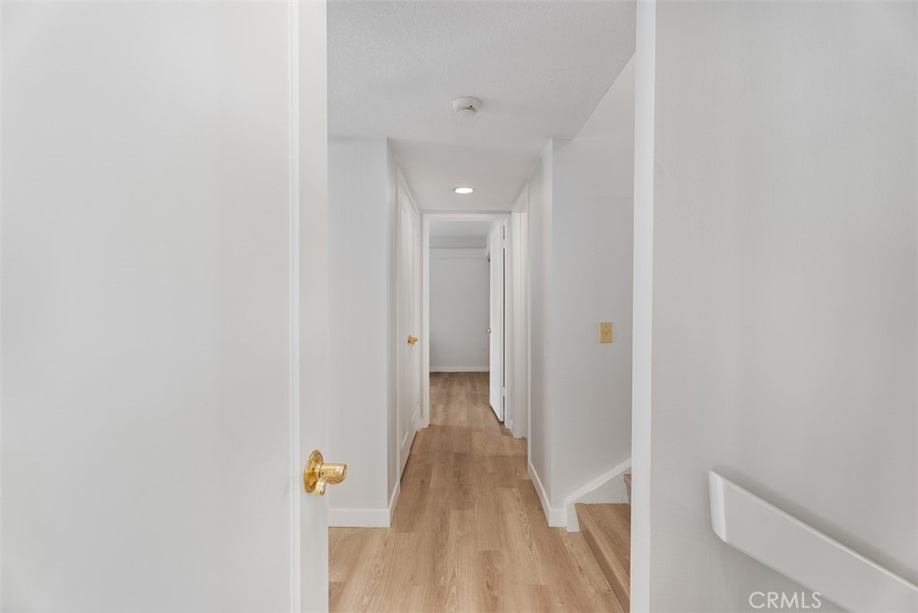 165 Old Ranch Road, Unit 3 Seal Beach, CA 90740 - Photo 17 of 31 Main level hallway to main level secondary bedroom