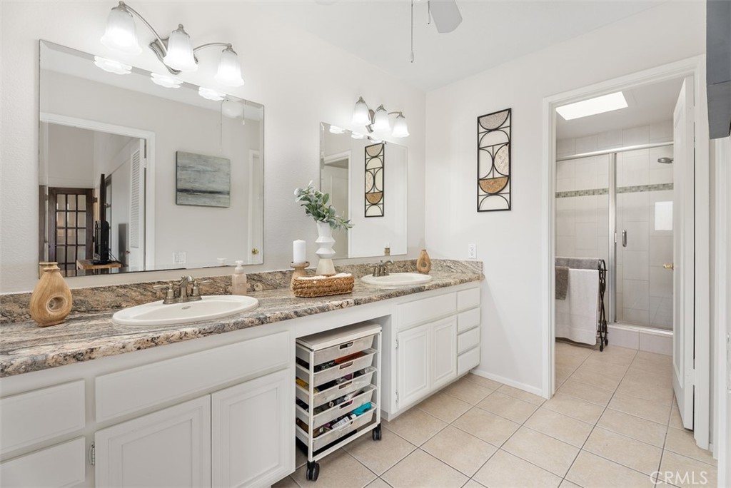 165 Old Ranch Road, Unit 3 Seal Beach, CA 90740 - Photo 28 of 31 Primary bathroom with dual vanities, walk-in shower, huge walk-in closet and separate soaking tub space