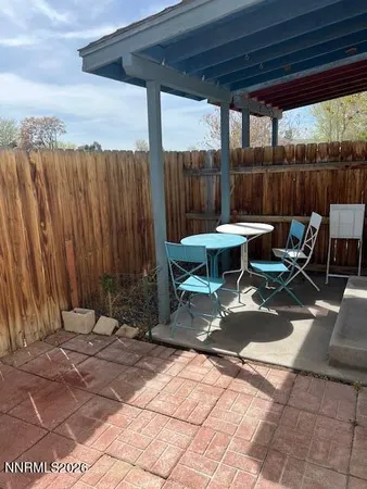 a backyard of a house with table and chairs