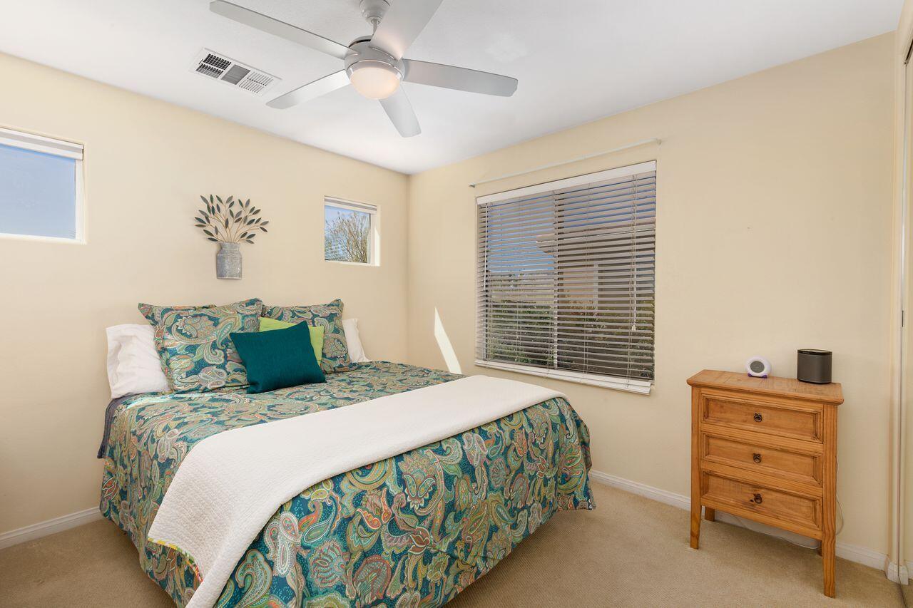 80591 Tangelo Court Indio, CA 92201 - Photo 26 of 30 a bedroom with a bed a dresser and a window
