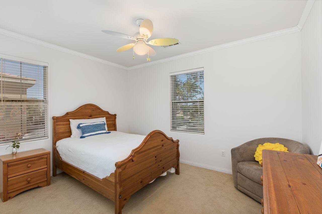 80591 Tangelo Court Indio, CA 92201 - Photo 27 of 30 a bedroom with a bed and a chandelier
