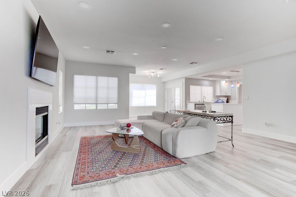 1 Rising Sun Court Henderson, NV 89074 - Photo 6 of 47 A well-lit, open-concept living space seamlessly connects to the kitchen, offering optimal flow.
