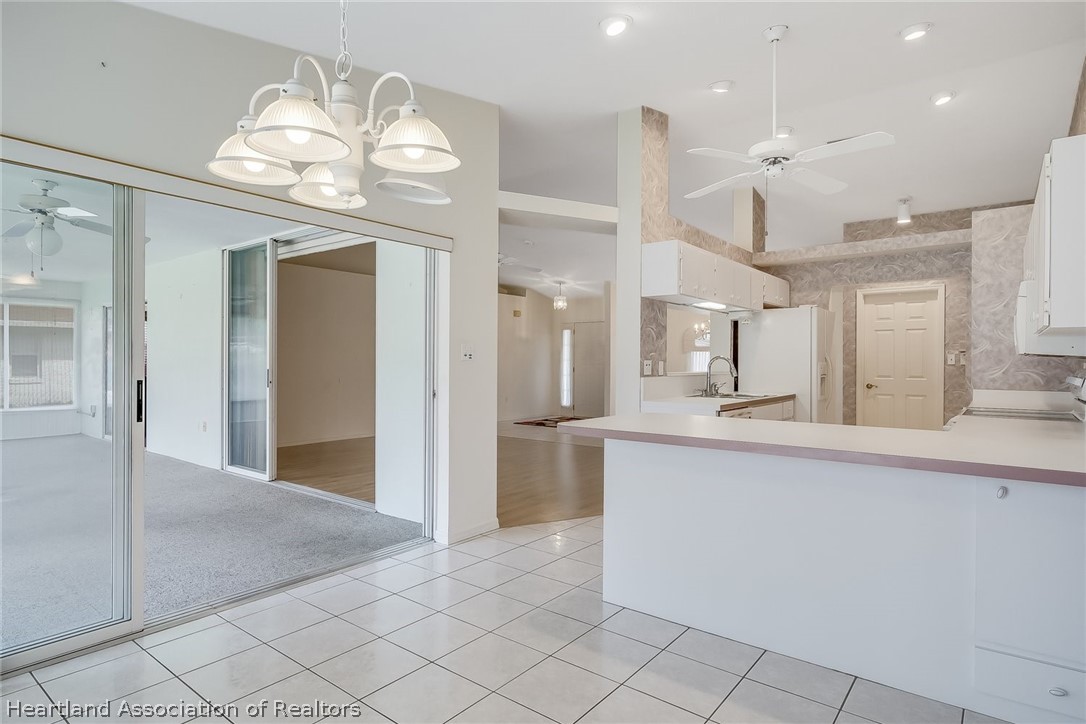 246 Tangerine Road Lake Placid, FL 33852 - Photo 11 of 36 an open kitchen with a sink and chandelier