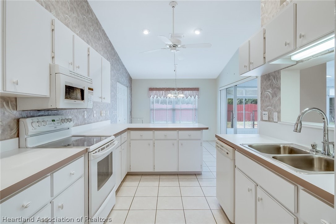 246 Tangerine Road Lake Placid, FL 33852 - Photo 14 of 36 a kitchen with a sink cabinets and window