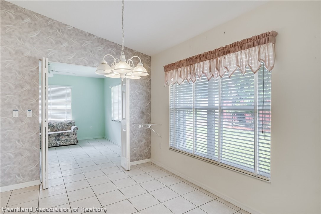 246 Tangerine Road Lake Placid, FL 33852 - Photo 16 of 36 a view of a hallway with windows and chandelier