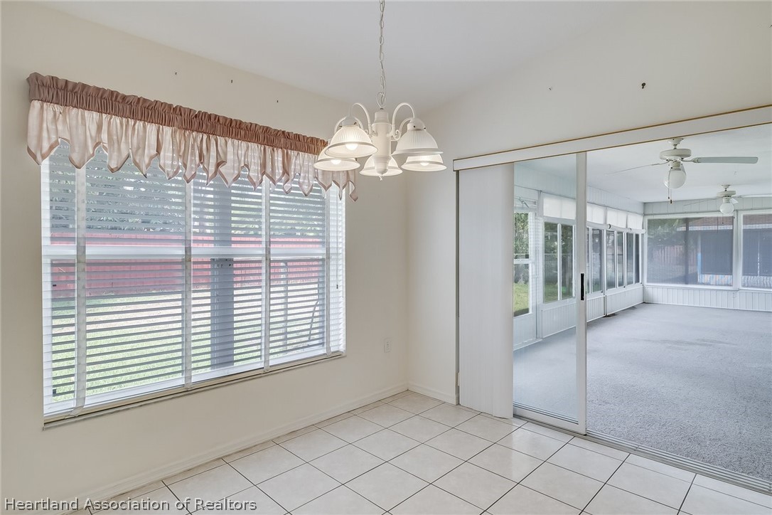 246 Tangerine Road Lake Placid, FL 33852 - Photo 17 of 36 a view of a livingroom with a chandelier fan and windows