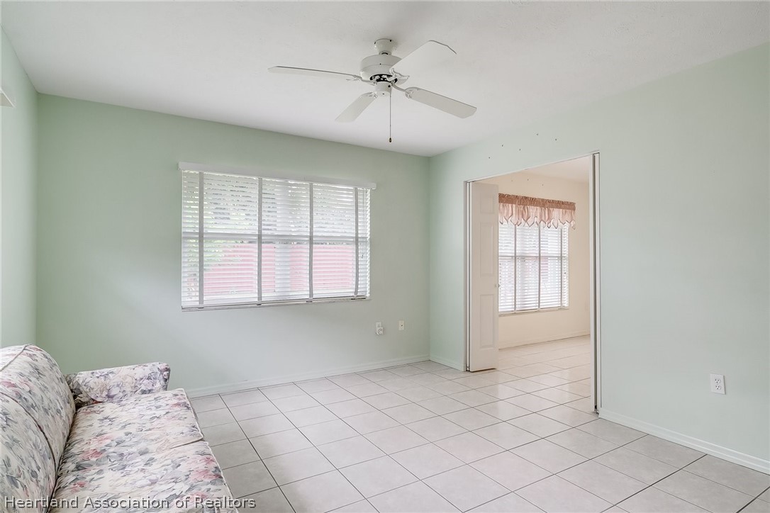 246 Tangerine Road Lake Placid, FL 33852 - Photo 23 of 36 a view of a bedroom with a bed and a ceiling fan