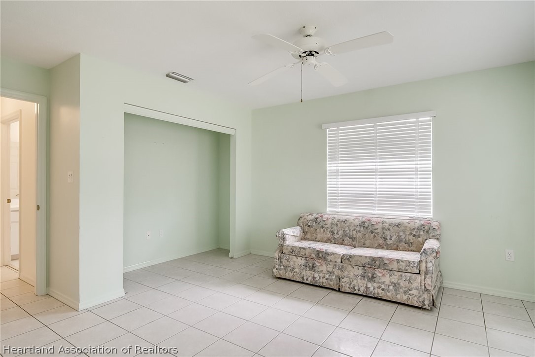 246 Tangerine Road Lake Placid, FL 33852 - Photo 24 of 36 a room with a chandelier and a window
