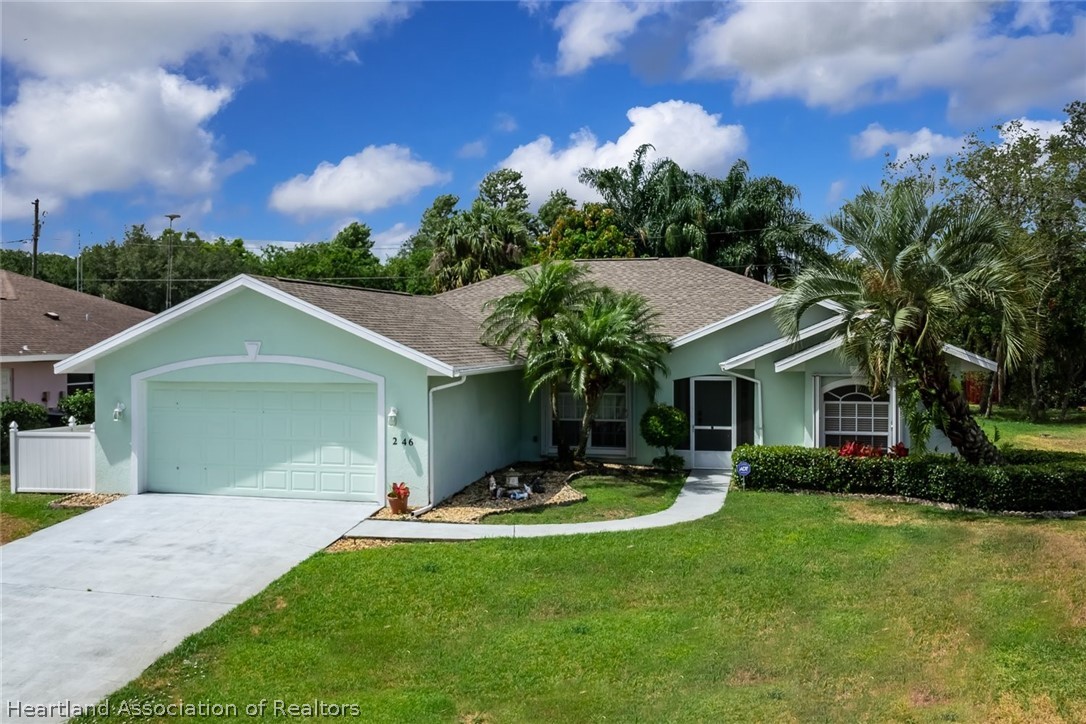 246 Tangerine Road Lake Placid, FL 33852 - Photo 30 of 36 a front view of a house with a yard and garage