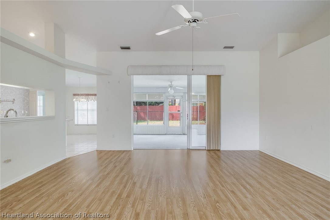 246 Tangerine Road Lake Placid, FL 33852 - Photo 3 of 36 an empty room with wooden floor and windows
