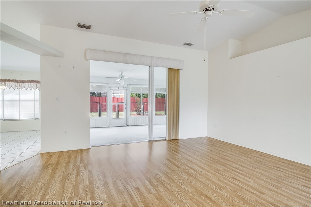 246 Tangerine Road Lake Placid, FL 33852 - Photo 4 of 36 a view of an empty room with wooden floor and a window