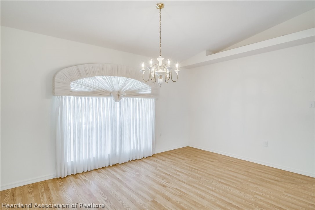 246 Tangerine Road Lake Placid, FL 33852 - Photo 6 of 36 a view of a chandelier fan and wooden floor