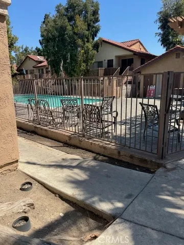 a view of a house with a small yard and wooden fence