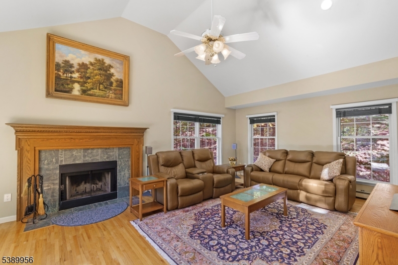 3 Hidden Hills Road Oak Ridge, NJ 07438 - Photo 11 of 32 a living room with furniture a fireplace and a table