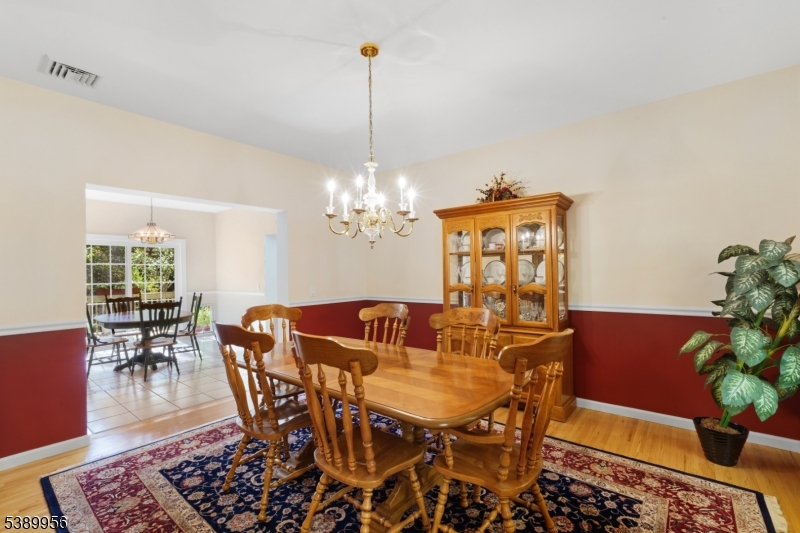 3 Hidden Hills Road Oak Ridge, NJ 07438 - Photo 12 of 32 a view of a dining room with furniture and wooden floor